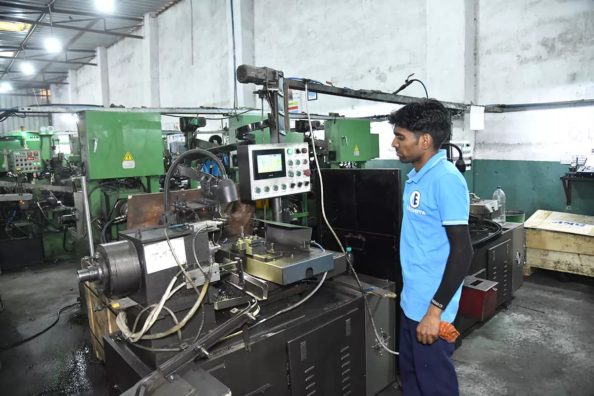 A machine operator at a precision turning station on the bearing line